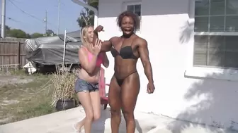 Black woman lifts white girl
