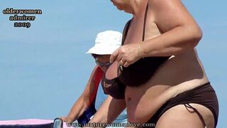 Fine Enormous titted old lady in bikini at the beach