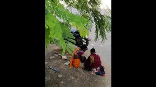 Indian poor women giving milk in public